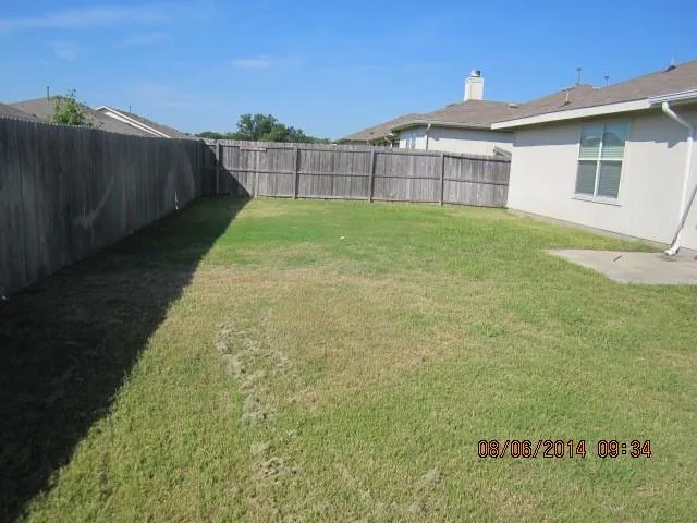 a view of a backyard with a garden and deck