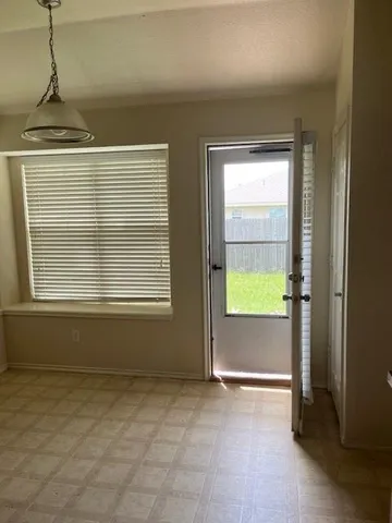 a view of an empty room with a window