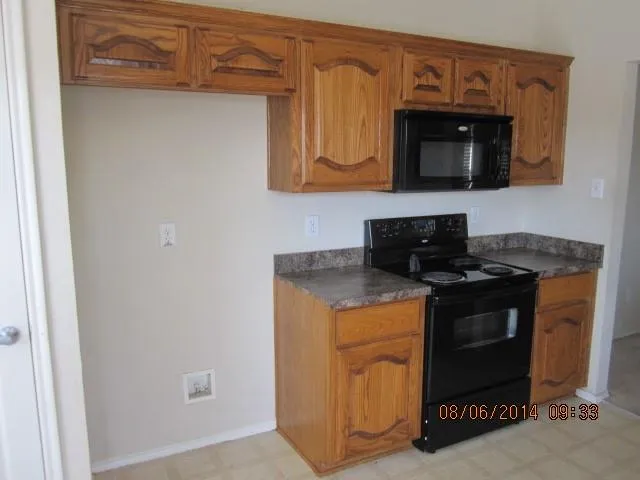 a kitchen with stainless steel appliances granite countertop a stove and a microwave