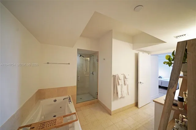 a bedroom with a bed and large window