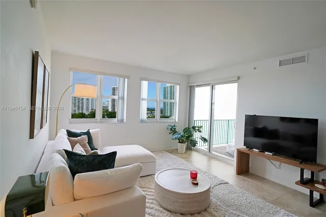 a living room with furniture and a flat screen tv
