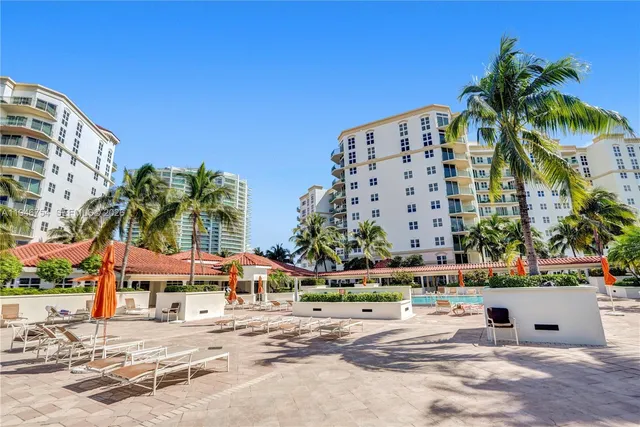 a dining room with furniture and chandelier