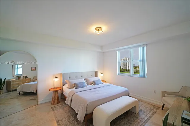 a bedroom with a bed and a lamp