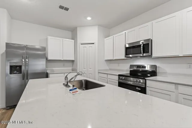 a bathroom with a sink a toilet a mirror and vanity