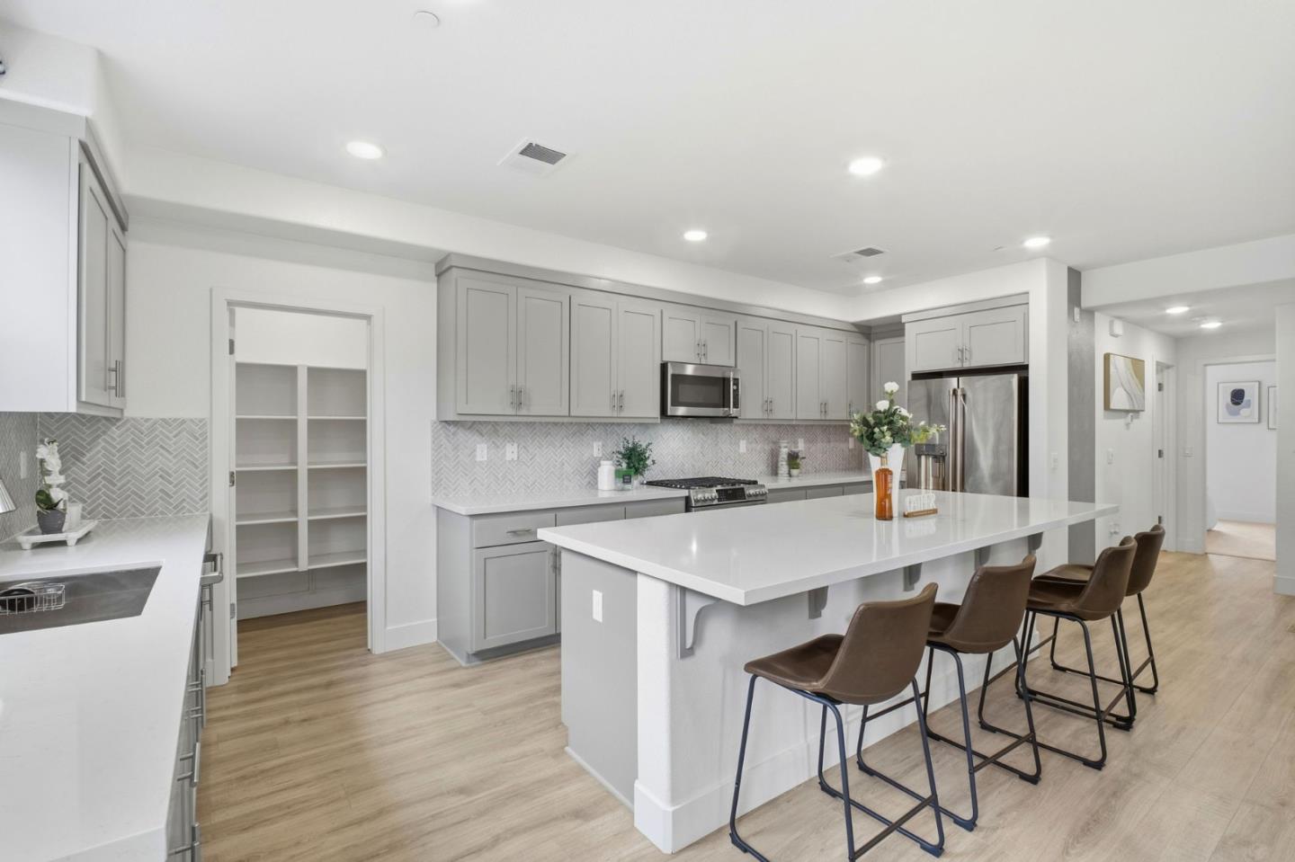 385 Line Street Hayward, CA 94544 - Photo 7 of 38 a kitchen with a dining table cabinets appliances and wooden floor