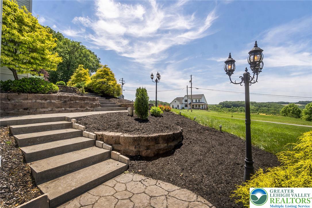 9461 Red Road Kempton, PA 19529 - Photo 44 of 55 Stone steps ascend through lush landscaping toward a welcoming home.