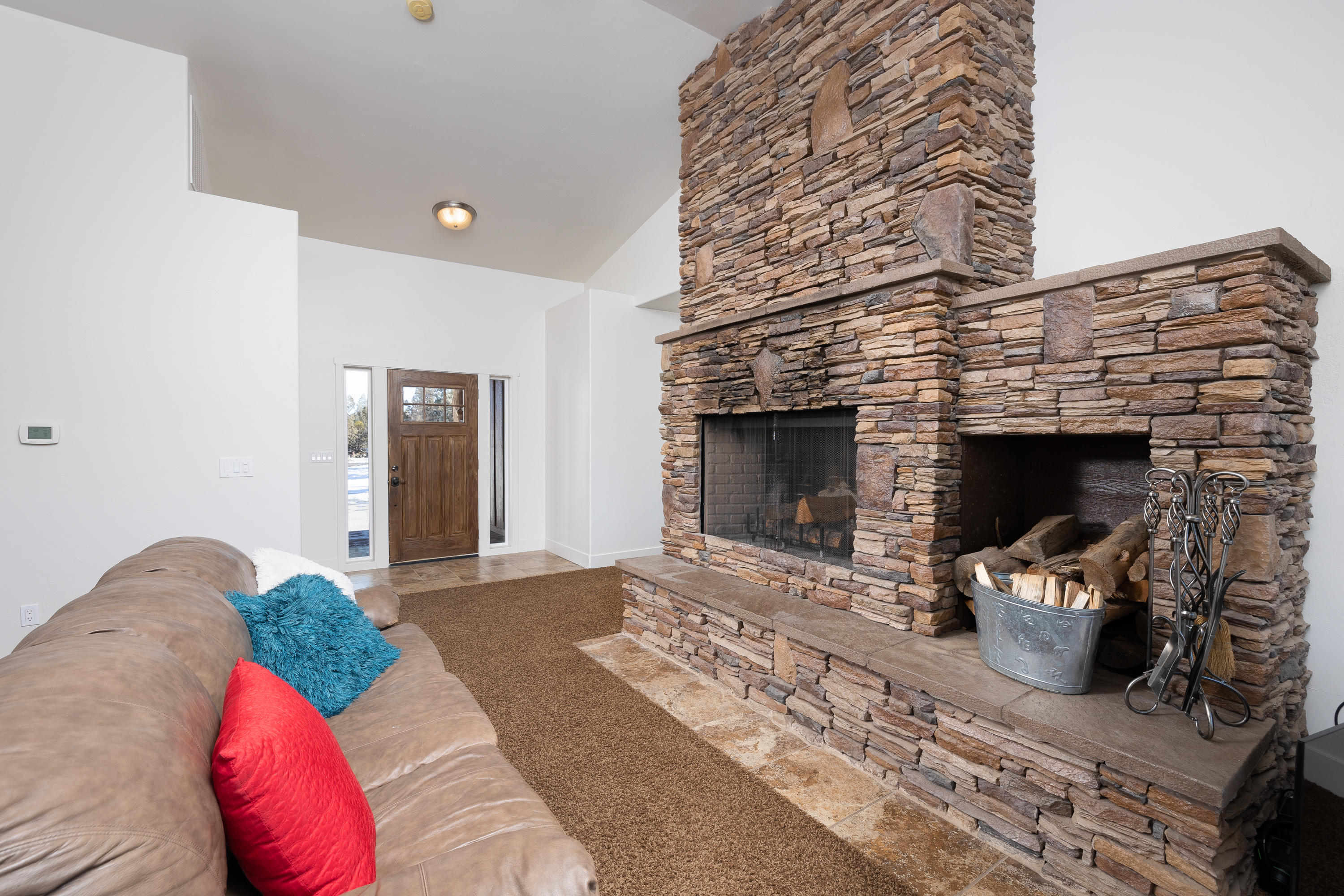 61822 Ten Barr Ranch Road Bend, OR 97701 - Photo 12 of 50 a living room with furniture and a fireplace