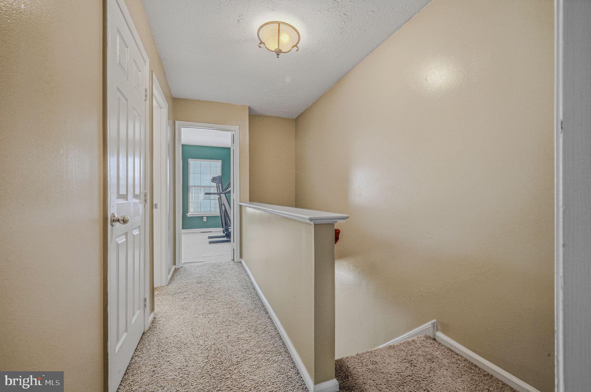104 Balmoral Way Newark, DE 19702 - Photo 14 of 25 a view of a hallway with wooden floor