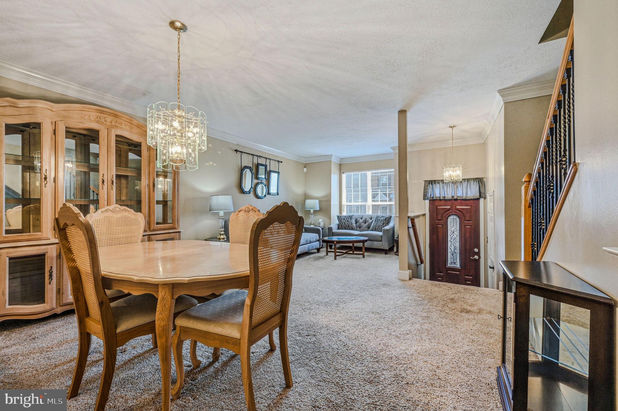 104 Balmoral Way Newark, DE 19702 - Photo 7 of 25 a view of a dining room with furniture and a chandelier
