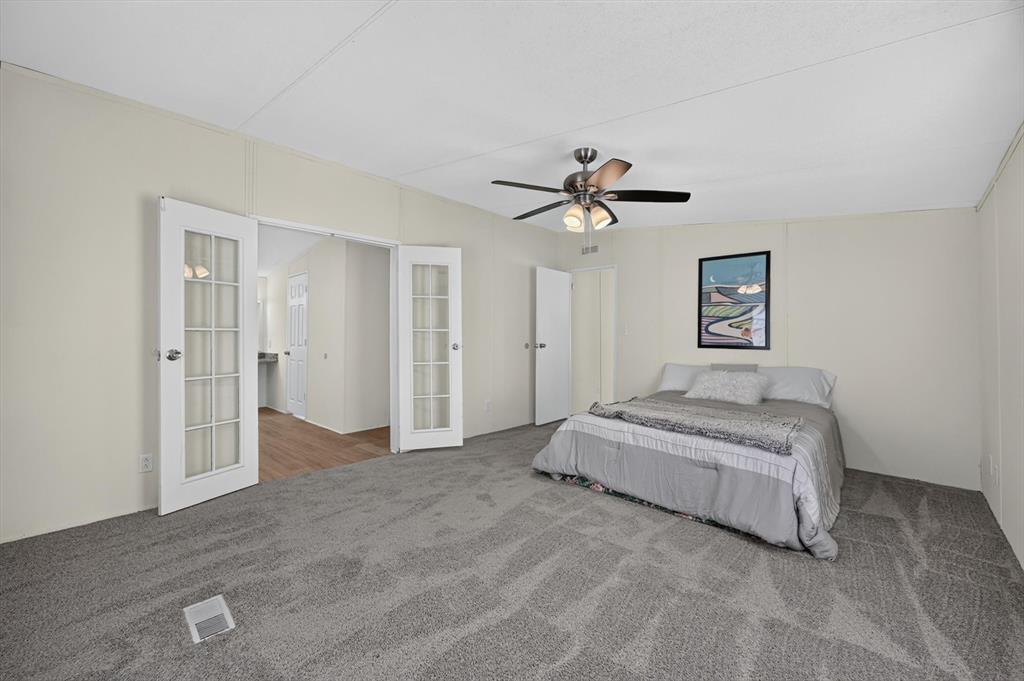 13405 Wheat Road Venus, TX 76084 - Photo 25 of 32 Spacious room featuring gray patterned carpet, a ceiling fan with light fixture, and white walls