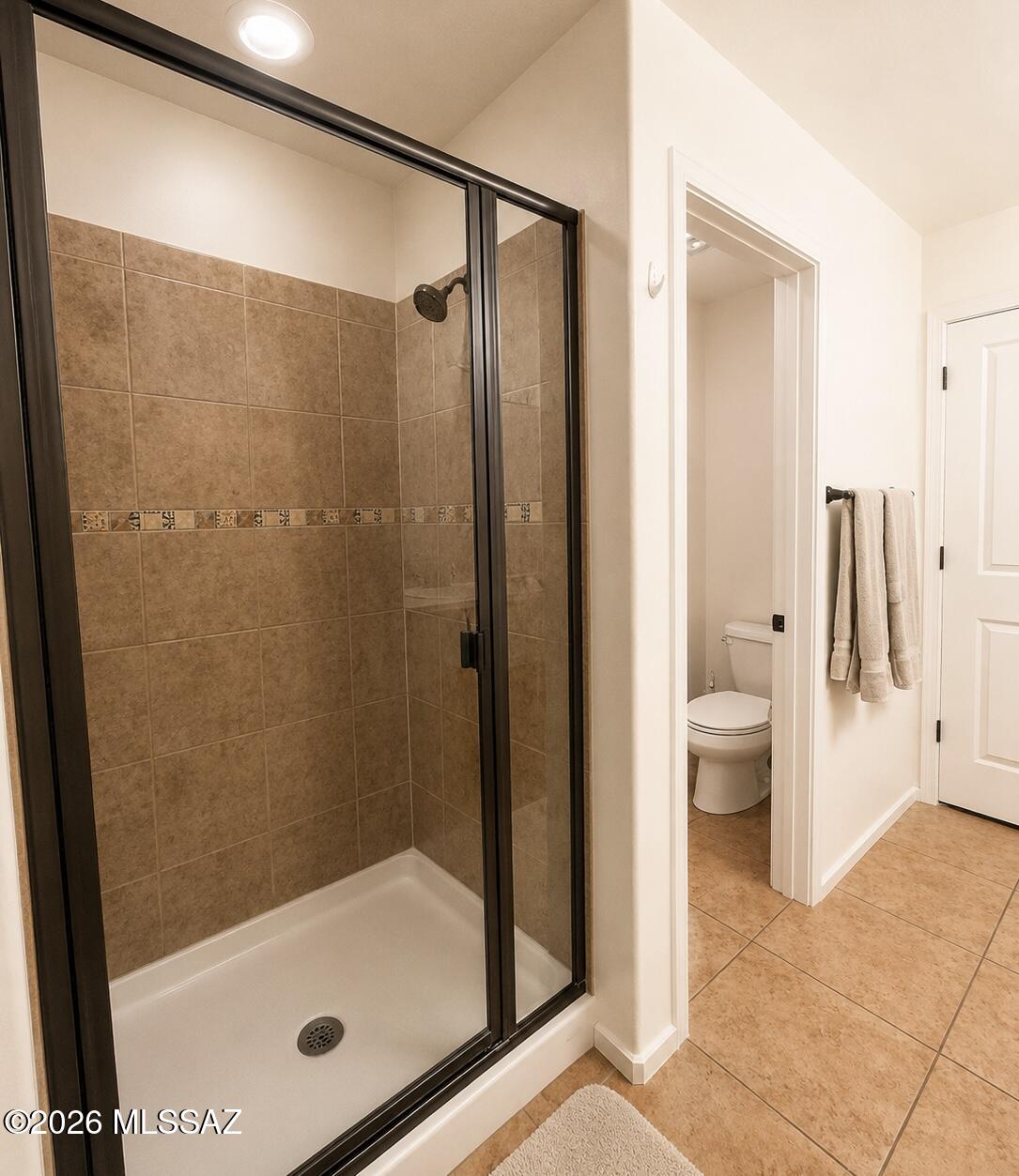 2018 East River Road, Unit 102 Tucson, AZ 85718 - Photo 17 of 25 a bathroom with a glass shower door