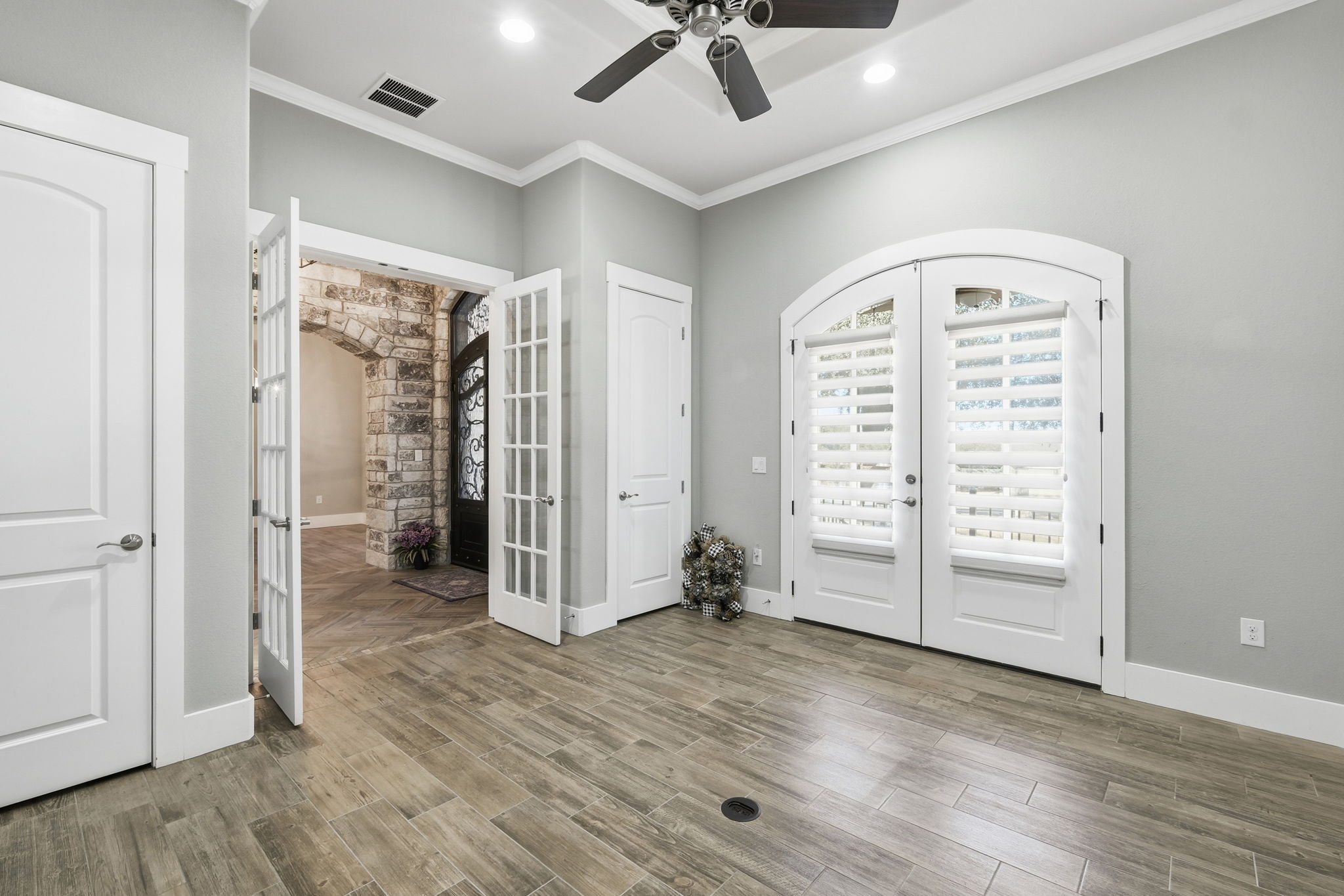 403 Highland Spring Lane Georgetown, TX 78633 - Photo 17 of 40 Unfurnished bedroom featuring french doors, wood finish floors, ornamental molding, ceiling fan, and access to exterior