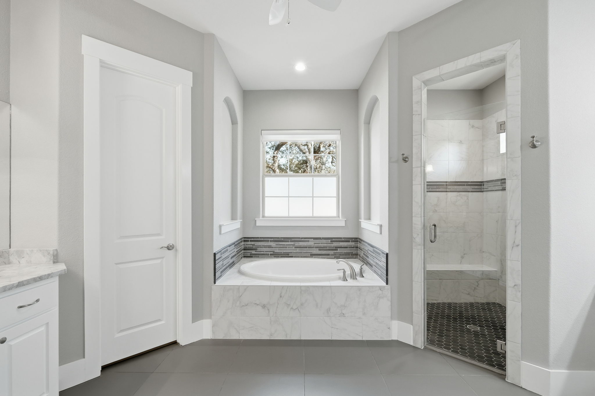 403 Highland Spring Lane Georgetown, TX 78633 - Photo 20 of 40 Full bathroom with a stall shower, a garden tub, vanity, tile patterned floors, and recessed lighting