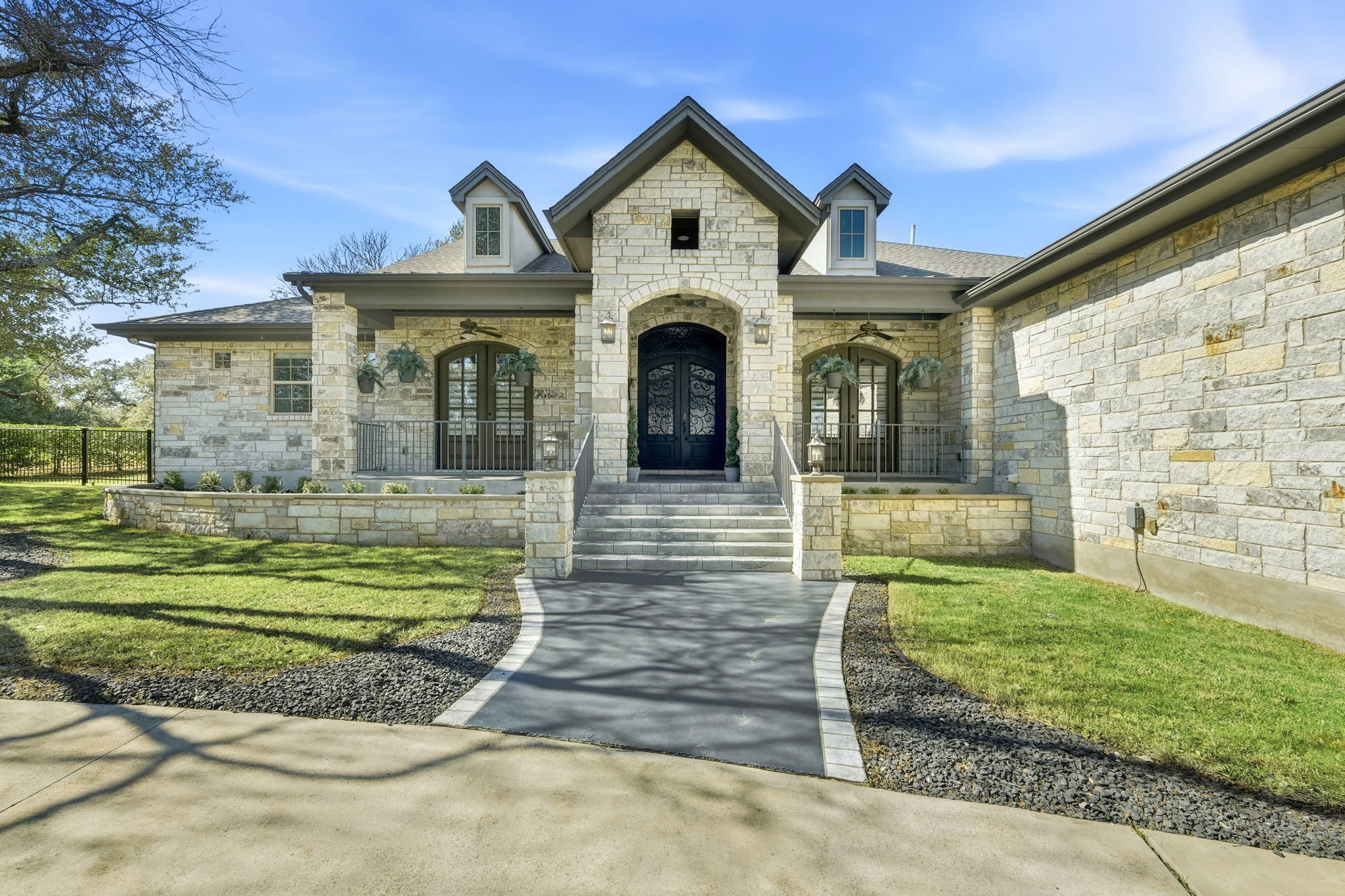 403 Highland Spring Lane Georgetown, TX 78633 - Photo 6 of 40 Entrance to property featuring stone siding, covered porch, french doors, and a yard