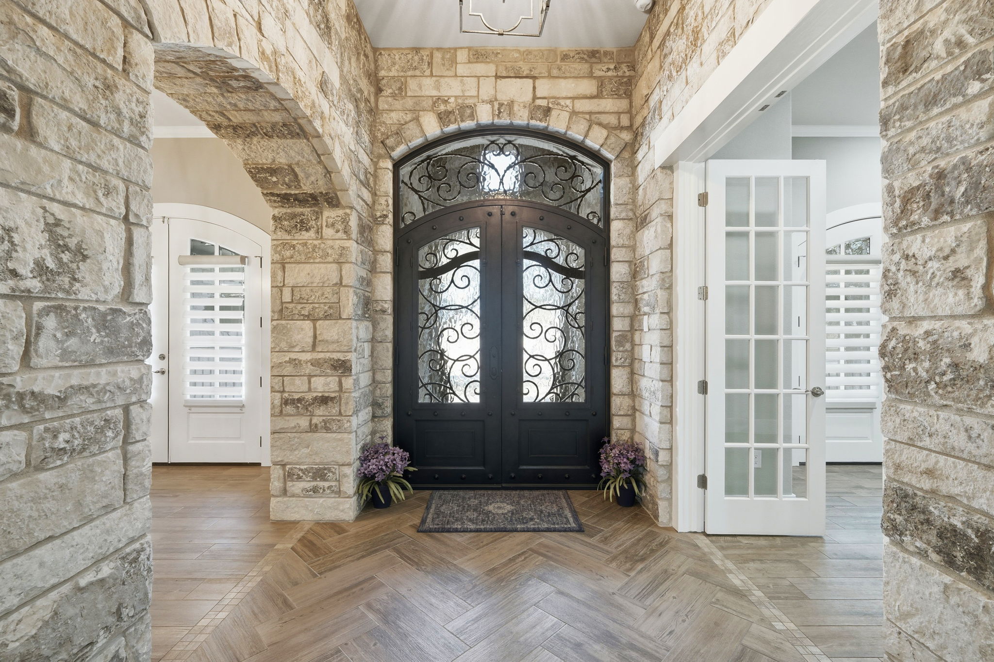 403 Highland Spring Lane Georgetown, TX 78633 - Photo 7 of 40 Foyer entrance with arched walkways, french doors, parquet flooring, a chandelier, and ornamental molding