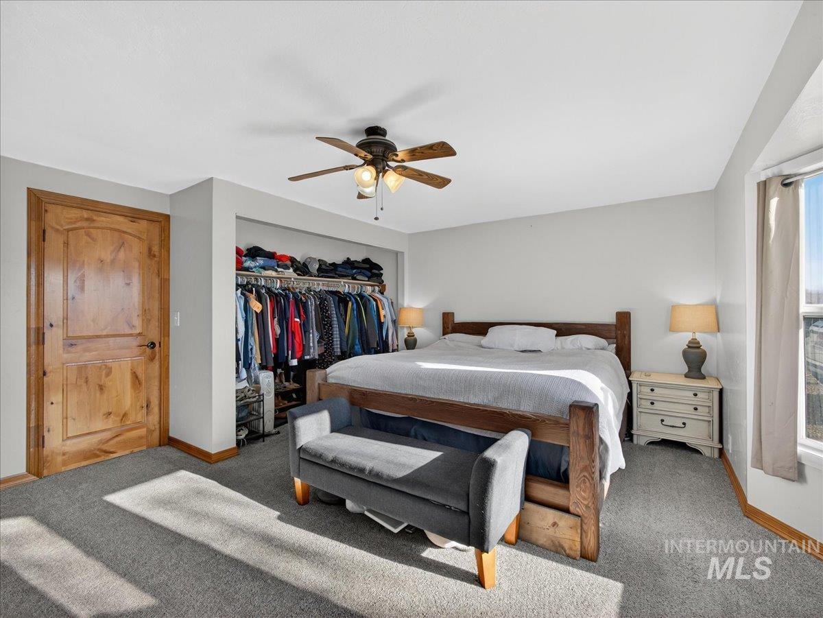 2588 West Sales Yard Road Emmett, ID 83617 - Photo 24 of 49 Carpeted bedroom featuring ceiling fan and a closet