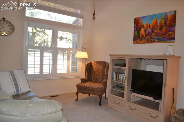 a living room with furniture fireplace and window