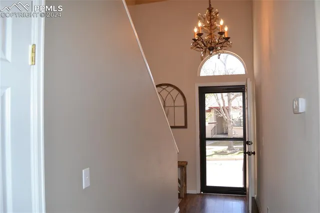 a view of entryway with wooden floor and chandelier