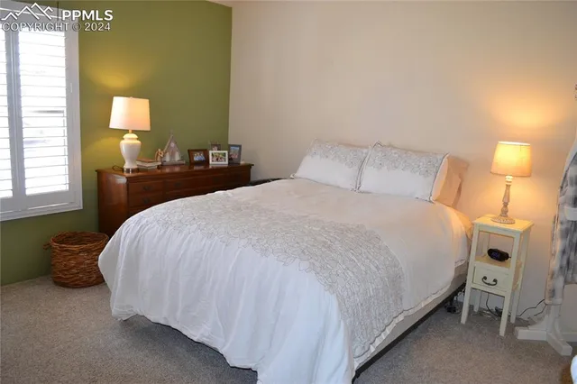 a bedroom with a bed and a lamp