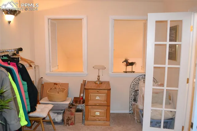 a view of a bedroom with flooring & chairs