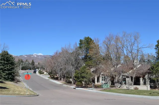 a view of a house with a small yard and wooden fence