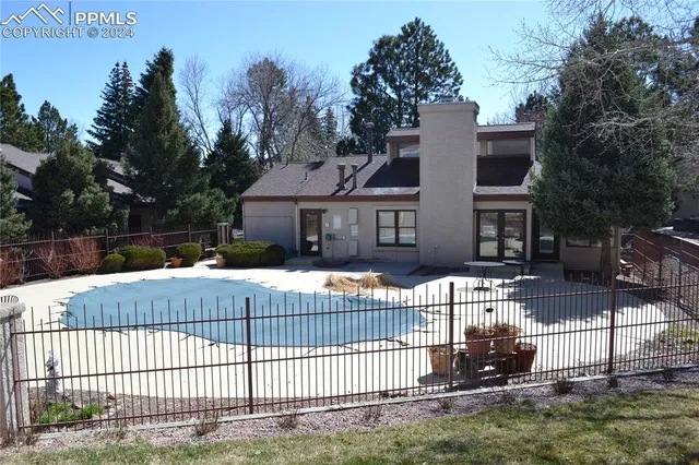 a white house that has a tree in front of it