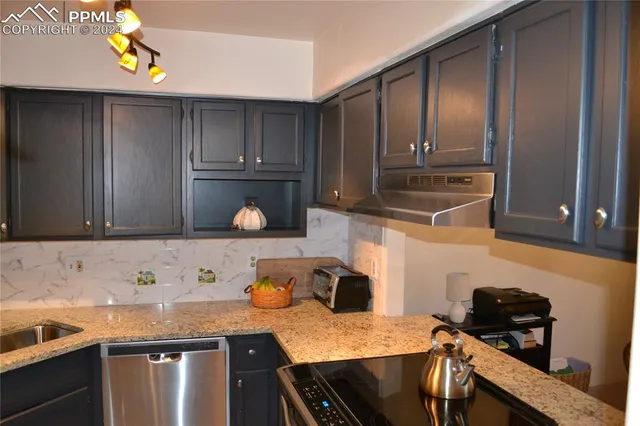 a kitchen with a sink a stove and cabinets