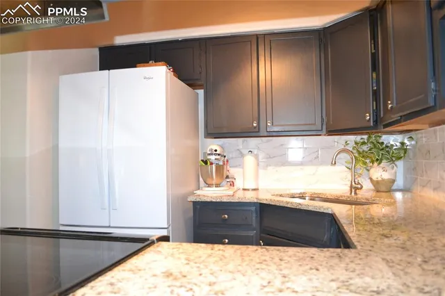 a kitchen with a refrigerator and a sink