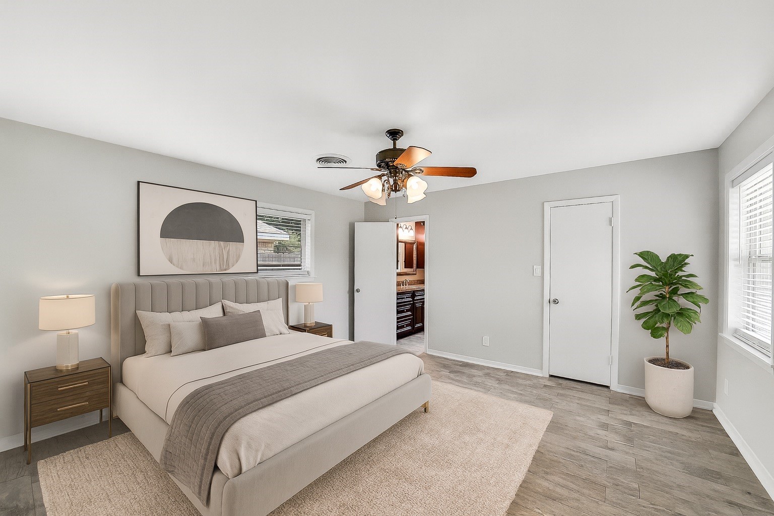 10135 Knoboak Drive Houston, TX 77080 - Photo 15 of 26 Spacious primary suite features a ceiling fan with light, and windows overlooking both the backyard and side of the home. This retreat includes a walk-in closet with built-in shelving and hanging space plus direct access to the en suite bathroom. Large room can easily accommodate a king-size bed and additional furnishings, creating a comfortable and private retreat. Note: this image has been virtually staged.