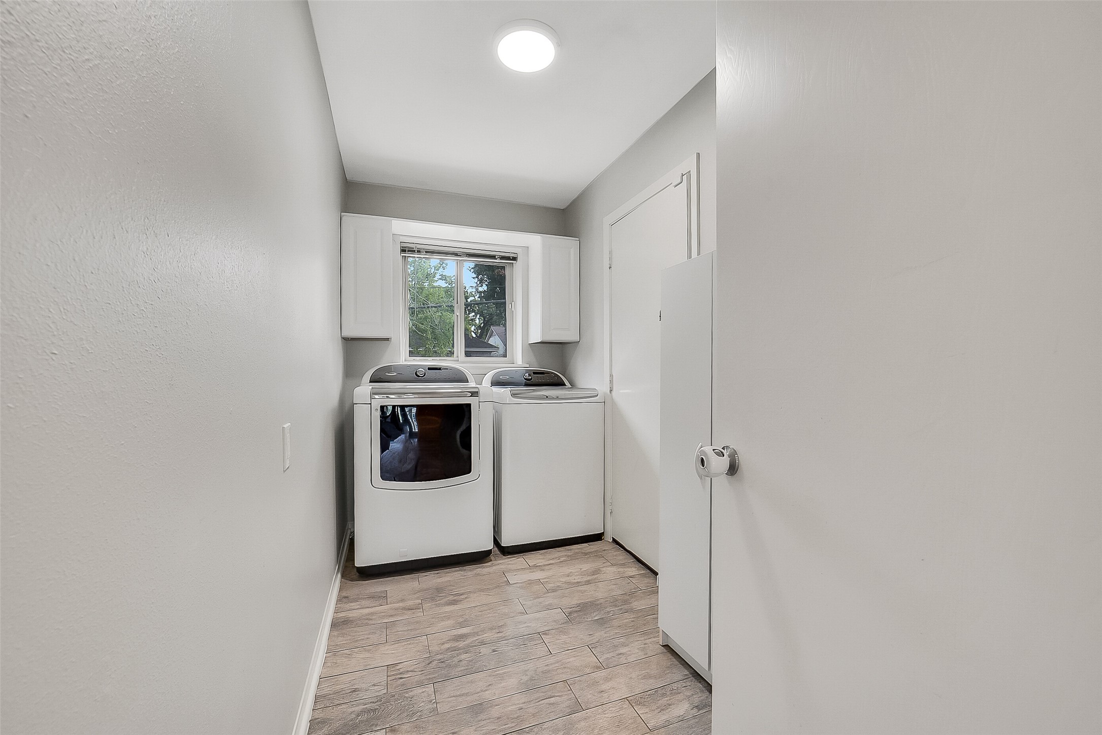 10135 Knoboak Drive Houston, TX 77080 - Photo 24 of 26 Dedicated utility room with space for full-size appliances, including a washer and dryer that remain with the lease. A window overlooking the backyard brings in natural light, creating a bright and practical space for daily routines. Smart home comfort is enhanced with a Nest thermostat, keeping the AC easily controlled and energy efficient.