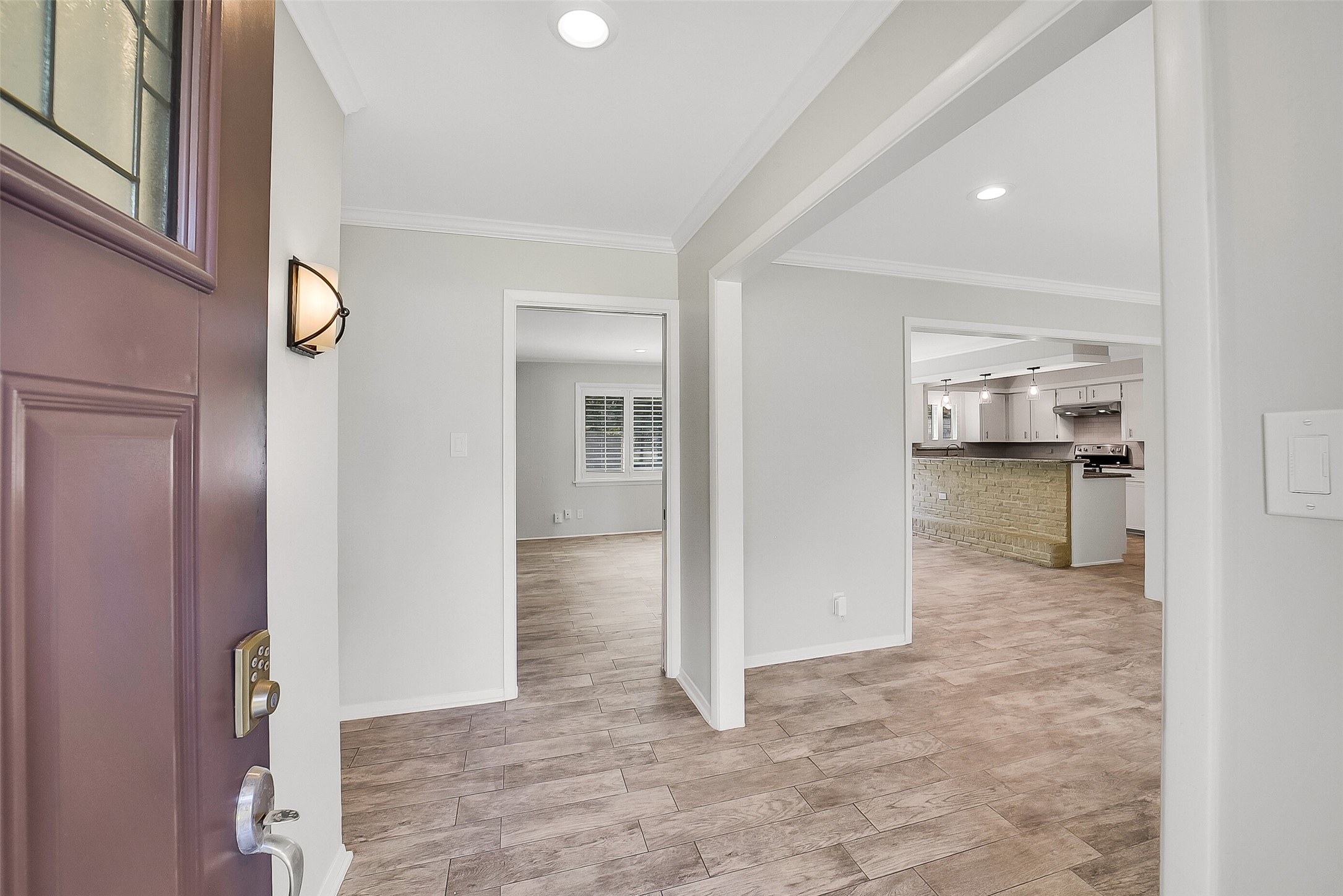 10135 Knoboak Drive Houston, TX 77080 - Photo 4 of 26 Step inside to a bright and welcoming foyer with clear sightlines to the home’s main spaces. To the right, a formal dining room provides an elegant setting for entertaining; straight ahead, the spacious living room serves as the central hub of the home. A hallway to the left leads to all four bedrooms, offering separation and privacy from the main living areas.