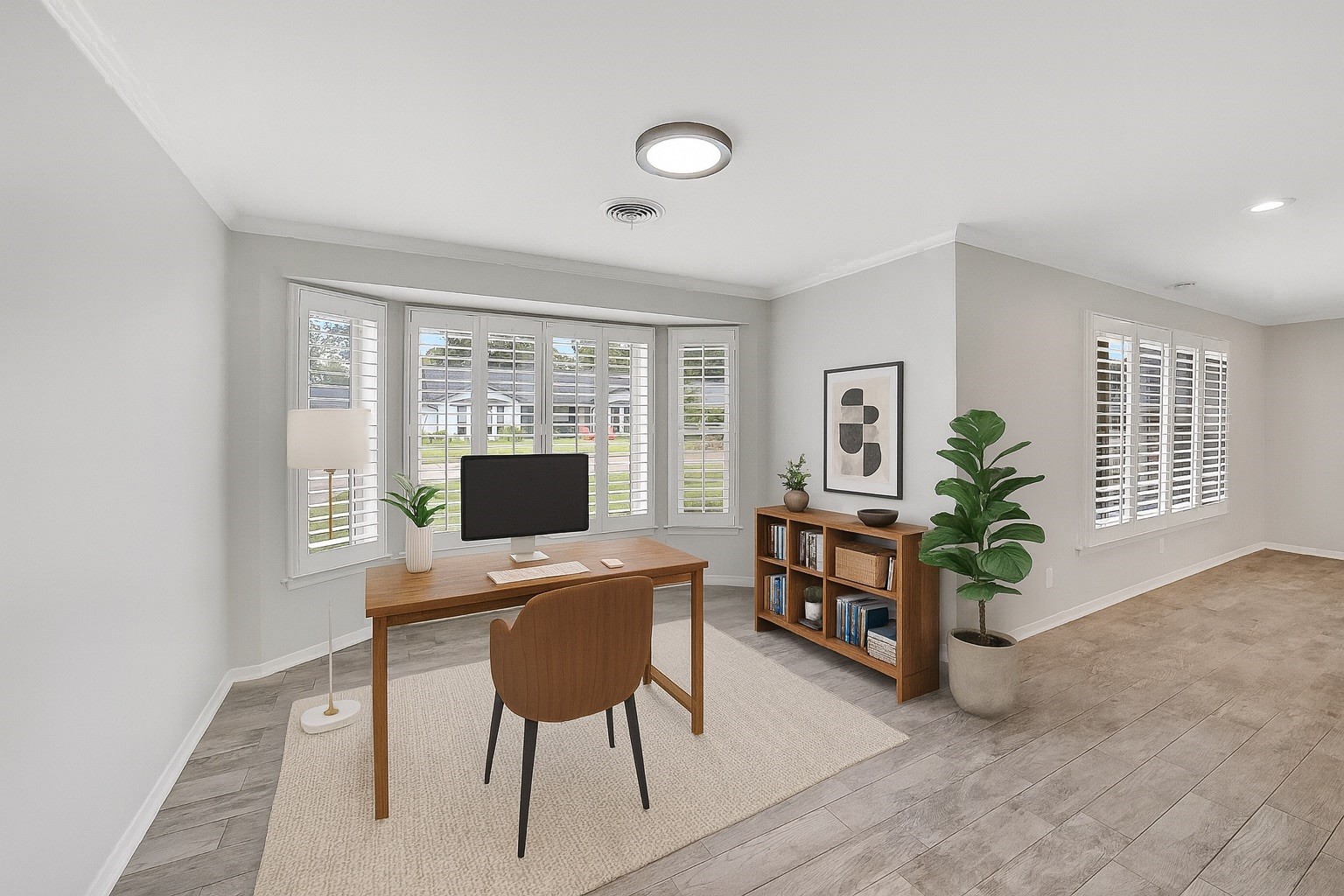 10135 Knoboak Drive Houston, TX 77080 - Photo 7 of 26 Versatile flex space just off the breakfast area, currently staged as a home office. Four large windows with plantation shutters overlook the front yard, creating a bright and inspiring atmosphere. The open connection to the dining room enhances the flow, making this room adaptable for work, play, or additional living. This space could also make a perfect play room, dining room option or even a formal living. Note: this image has been virtually staged.