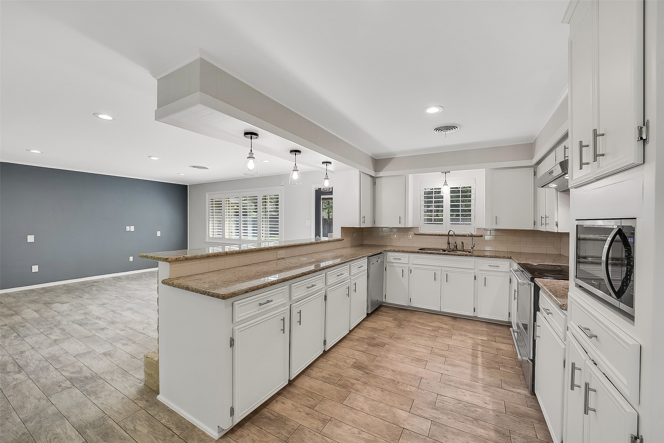 10135 Knoboak Drive Houston, TX 77080 - Photo 10 of 26 Spacious kitchen with abundant counter space and cabinetry for storage. The counter easily accommodates barstool seating, making it a perfect spot for casual dining or entertaining. A window above the sink overlooks the backyard, while a built-in water filtration system provides everyday convenience.