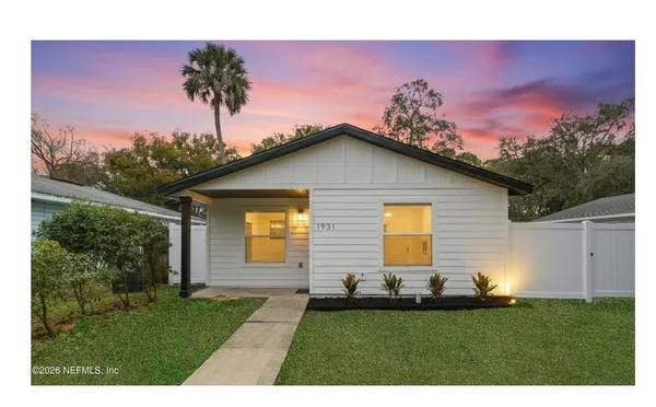 a front view of a house with a garden