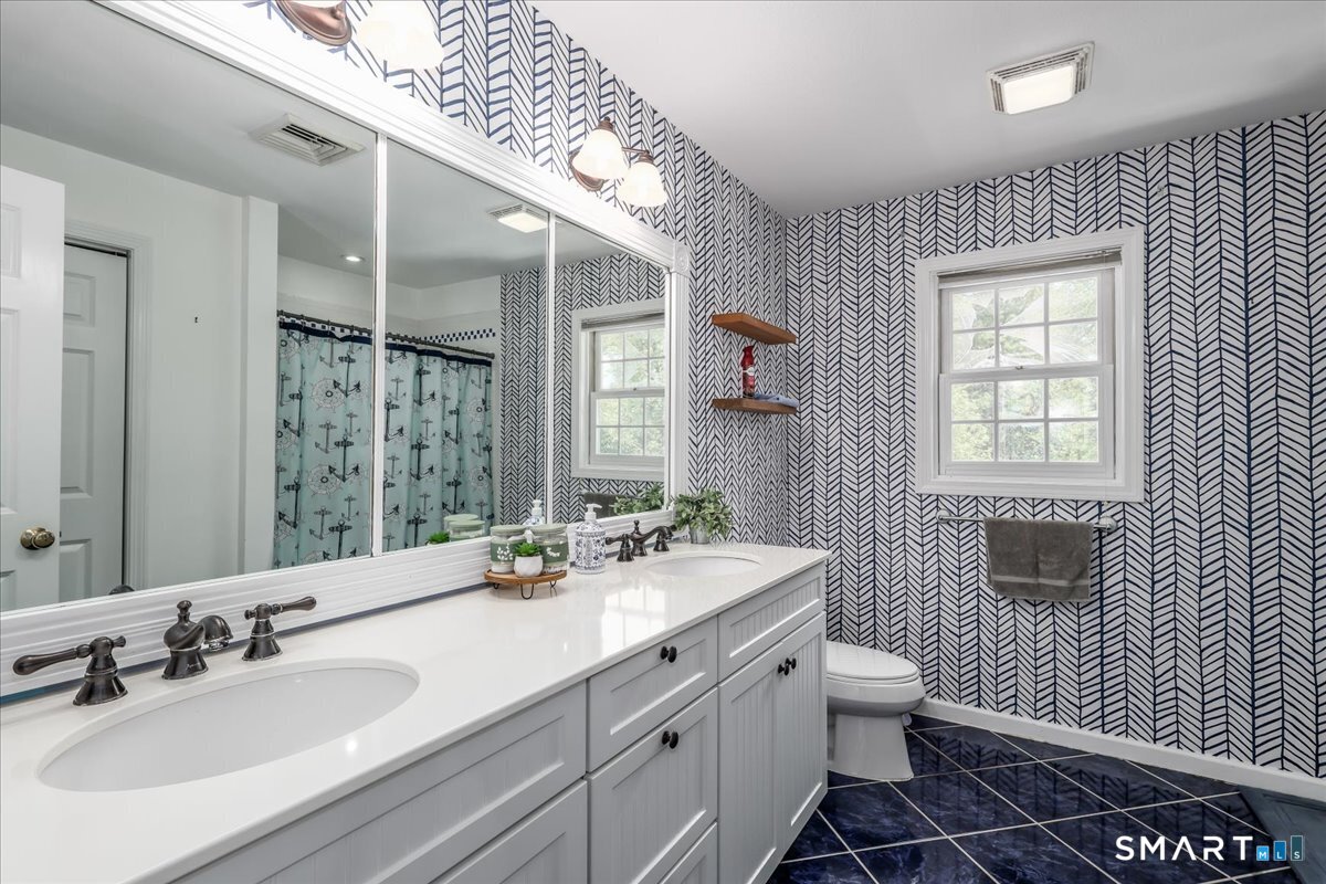 55 A Flax Hill Road Brookfield, CT 06804 - Photo 26 of 40 a bathroom with a double vanity sink a mirror and a toilet