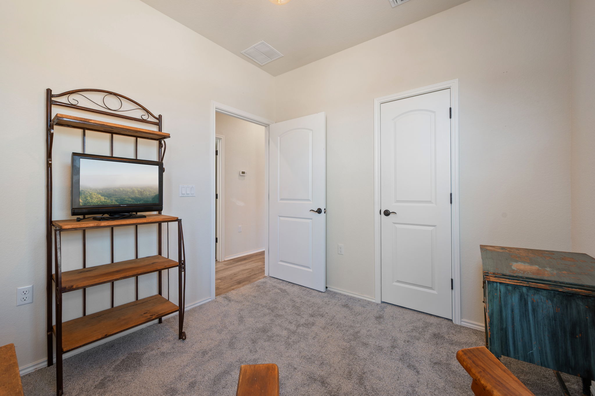 100 Bristol Cove Georgetown, TX 78633 - Photo 18 of 31 a living room with a flat screen tv and a book shelf
