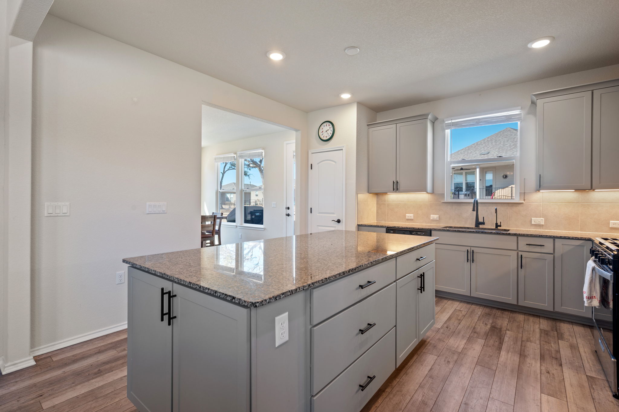 100 Bristol Cove Georgetown, TX 78633 - Photo 8 of 31 a kitchen with sink cabinets and wooden floor