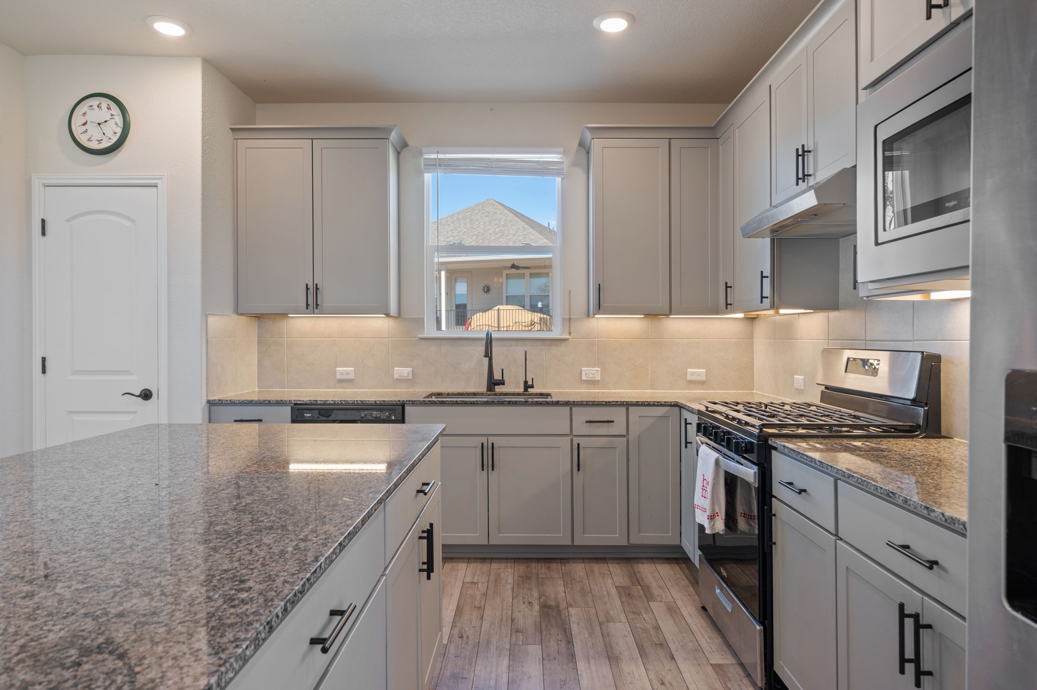 100 Bristol Cove Georgetown, TX 78633 - Photo 9 of 31 a kitchen with stainless steel appliances granite countertop a sink stove and refrigerator