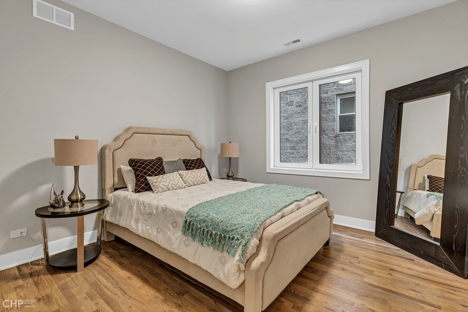 4101 South Drexel Boulevard, Unit 101 Chicago, IL 60653 - Photo 14 of 19 a bedroom with a bed and a mirror