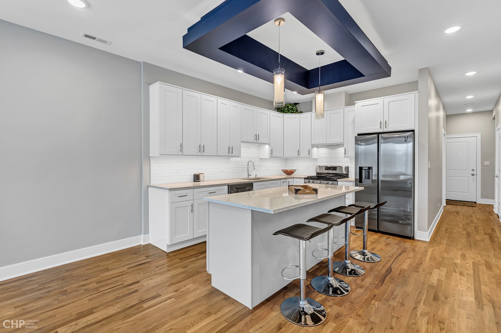 4101 South Drexel Boulevard, Unit 101 Chicago, IL 60653 - Photo 5 of 19 a kitchen with a sink stainless steel appliances and white cabinets