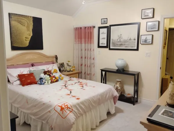 a bedroom with a bed and wall painting