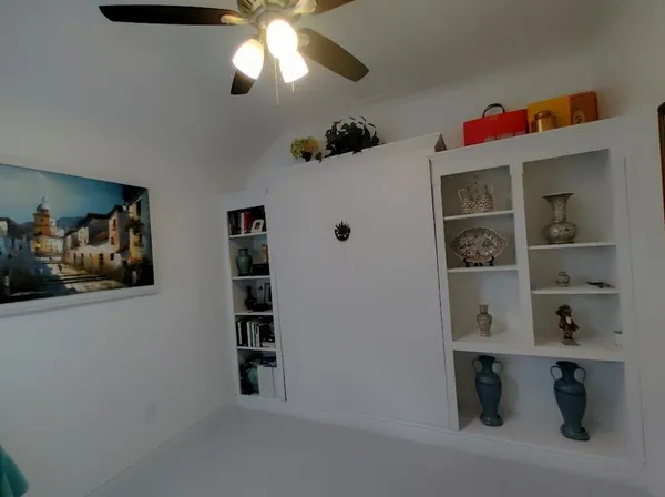 a view of a hallway with cabinet
