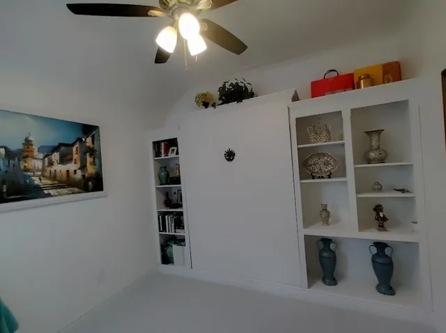 a view of a hallway with cabinet