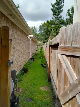 a view of a backyard with plants and a patio