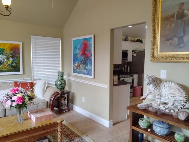 a living room with furniture and flowers