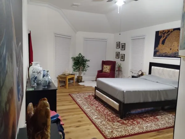 a bedroom with a bed and a chandelier