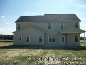 633 Pecan Grove Loop Hope Mills, NC 28348 - Photo 5 of 6 a view of a house with a yard