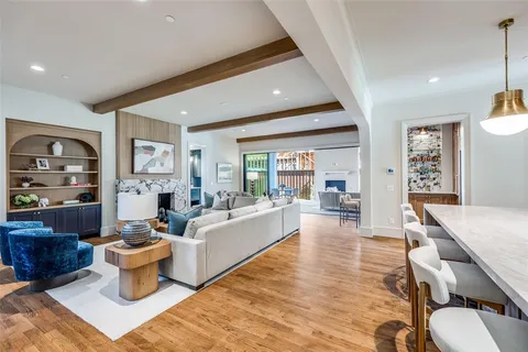 a living room with fireplace furniture and wooden floor