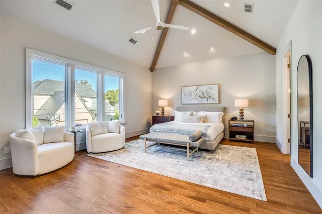 a bedroom with a large bed and a chandelier