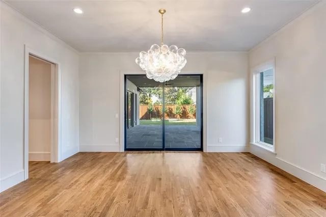 a view of a hallway with wooden floor and a fireplace